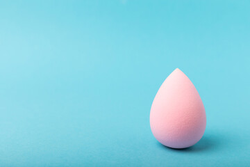 Beauty blender on blue background.Bright sponges for make-up cosmetics. Makeup products. Beauty concept. Place for text. Space for copy. Flat lay