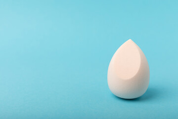 Beauty blender on blue background.Bright sponges for make-up cosmetics. Makeup products. Beauty concept. Place for text. Space for copy. Flat lay