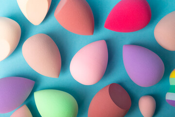 Beauty blender on blue background.Bright sponges for make-up cosmetics. Makeup products. Beauty concept. Place for text. Space for copy. Flat lay