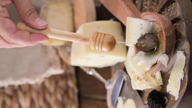 Pecorino cheese with truffle, traditional Italian sheep's milk cheese with truffle. A typical product of the dairy regions of Tuscany and Sardinia. Honey and cheese. High quality HD video. Vertical