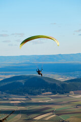 paraglider in the sky over the sun-drenched austrian valley