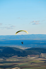 paraglider in the sky over the sun-drenched austrian valley