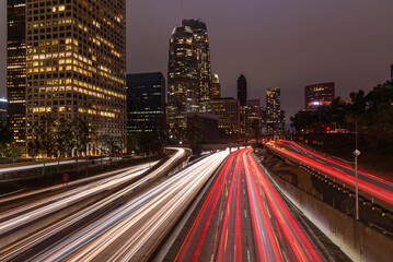 Los Angeles financial district skyline with rush hour traffic streaming along a freeway