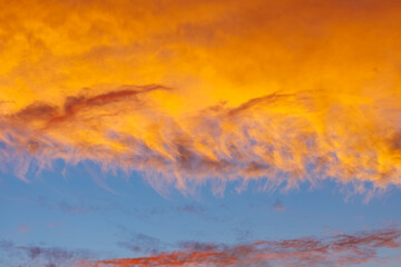 fiery orange clouds , surreal color of the sky
