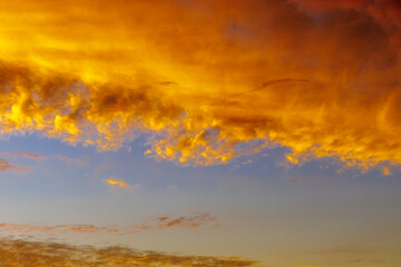 fiery orange clouds , surreal color of the sky