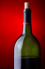 Closeup of a wine bottle on a red background
