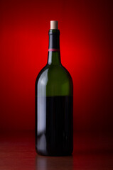 Closeup of a wine bottle on a red background