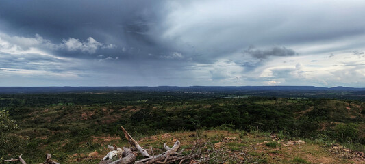 View of the horizon in an image of the native vegetation of Minas Gerais of Brazil with forested mountains and the cloudy sky with striking clouds