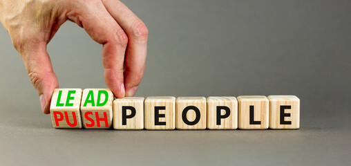 Lead or push people symbol. Concept word Lead people and Push people on wooden cubes. Beautiful grey table grey background. Businessman hand. Business Energy or hunger crisis concept. Copy space.
