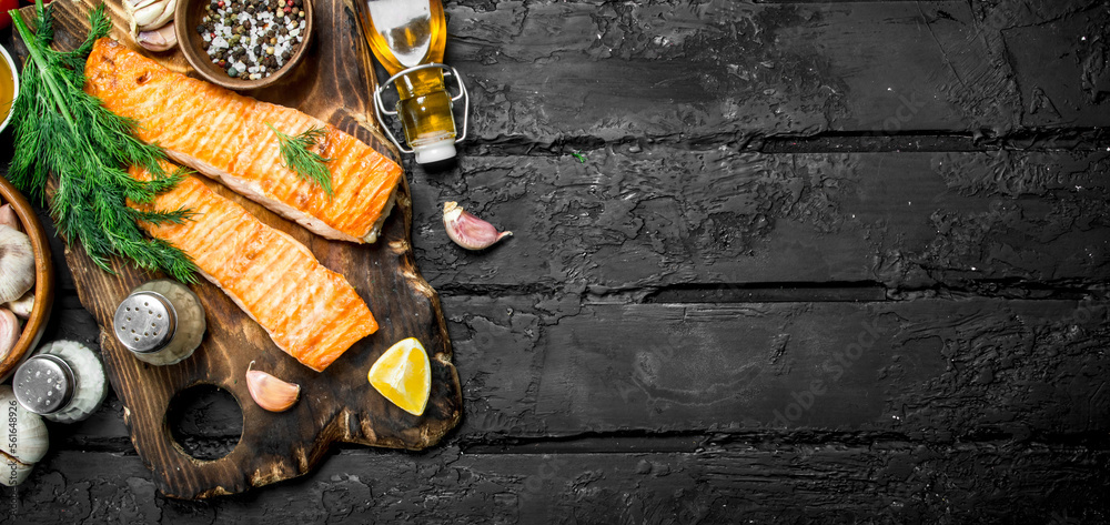 Sticker grilled salmon fillet with spices and dill branches.