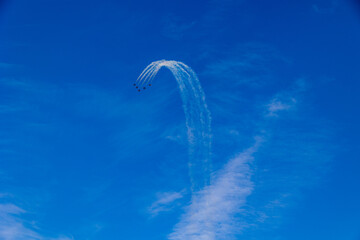  flight of five cessna planes over alicante smoke spanish flag against the blue sky