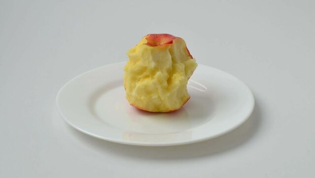 Apple on a plate. Eating process.