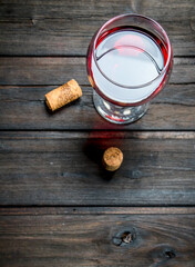 Wine background. A glass of red wine with corks.