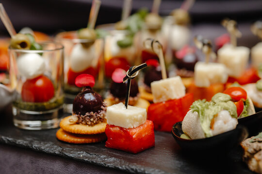 appetizing aperitifs on the plate , canape with cheese .