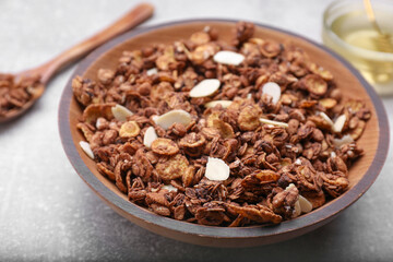 Tasty granola served with nuts and dry fruits on light grey table, closeup