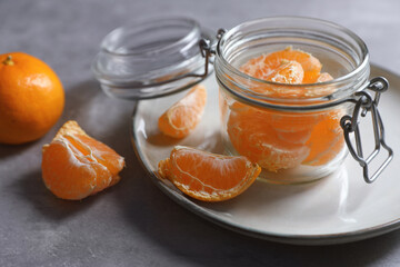 Fresh ripe tangerines on light grey table, closeup
