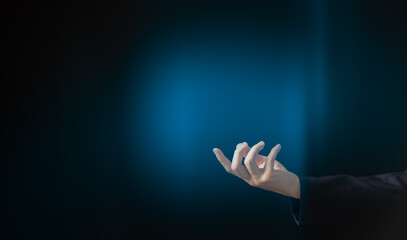 Businessman and gesture topic: a man in a black suit  hand gesture on an on abstract background in studio