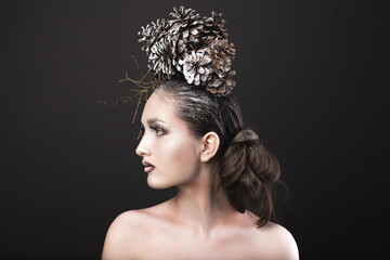 Elegant Girl in the New Year Wreath of Pine Cones