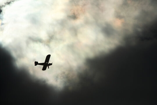 A Piper Cub overflys the New River Gorge against a sky filled with ominous clouds near Fayetteville ,WV