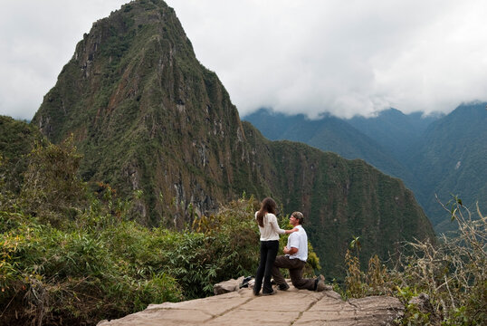 A young man asks for a young woman's hand in marriage in the ruins of Machu Picchu.