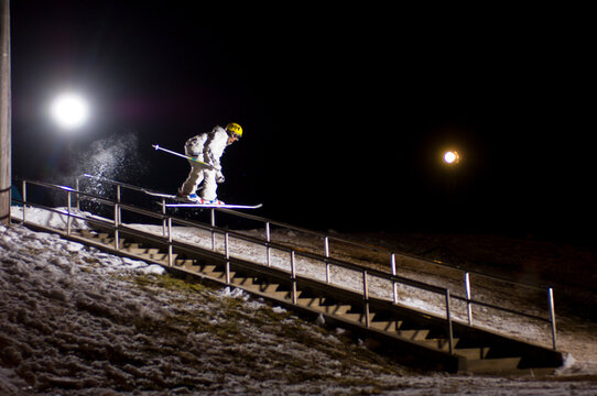 Woman sliding a rail on her skis in Salt Lake City, Utah