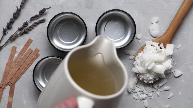 Close up of melted soy wax gets poured into small cans