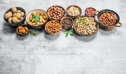 Fototapeta na wymiar Assortment of different nuts in bowls.