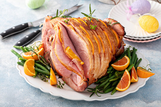 Easter ham stuffed with orange slices, spiral sliced glazed ham