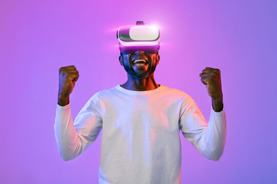 Emotional happy african american man trying virtual reality