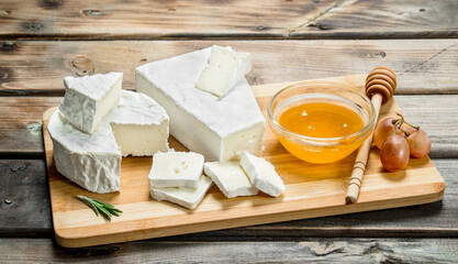 Brie cheese with nuts and honey on the Board.