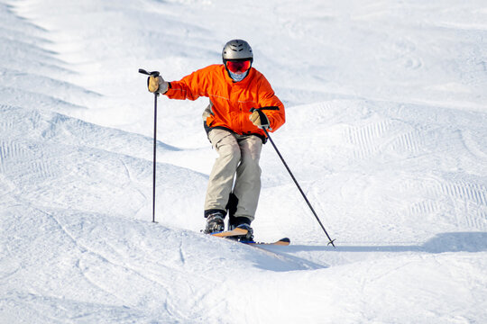People are enjoying mogul skiing snow boarding	