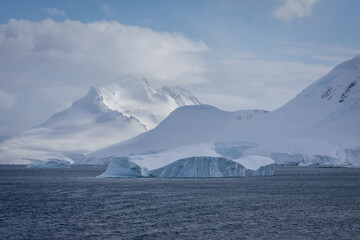drift ice in antarctica with mountains behind