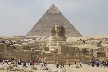 The Sphinx sits calmly in front of the pyramids of the Giza Plateau, Cairo, Egypt