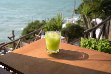 bicchiere con cocktail su di un tavolino in riva al mare