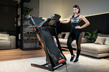 Fototapeta na wymiar female athlete prepare for training with treadmill