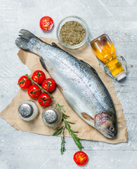Raw fish salmon with tomatoes, spices and rosemary.