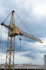 Fototapeta premium Construction site with tower crane under beautiful cloudy sky
