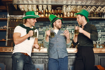 Men celebrate St. Patrick's Day at bar with a mug of beer