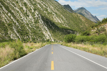 Naklejka premium Beautiful view of empty asphalt highway near mountains outdoors. Road trip