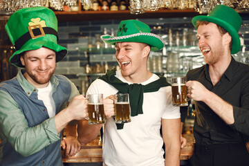 Men celebrate St. Patrick's Day at bar with a mug of beer