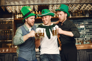 Men celebrate St. Patrick's Day at bar with a mug of beer