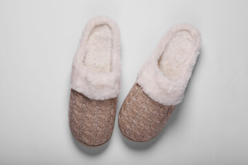 Pair of beautiful soft slippers on white background, top view