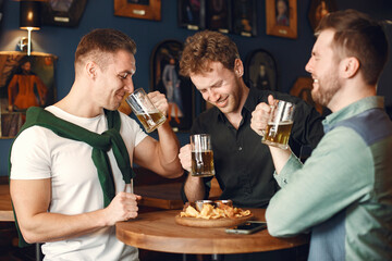 Men celebrate St. Patrick's Day at bar with a mug of beer