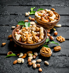 Assortment of different types of nuts in bowls.