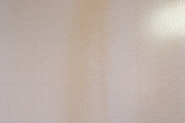 Abstract beige watercolor painting as background, top view