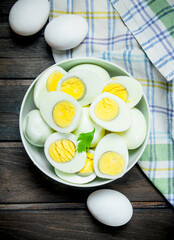 Boiled eggs in a bowl with parsley.