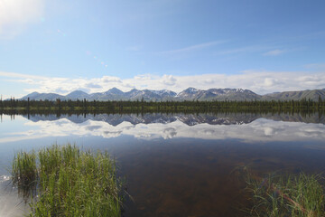 mountains in alaska with water reflection 