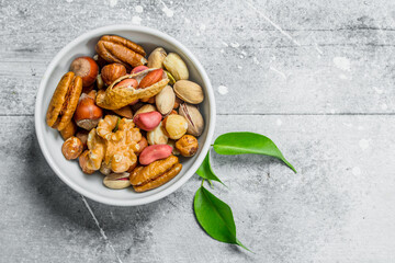 Different kinds of nuts in bowl .