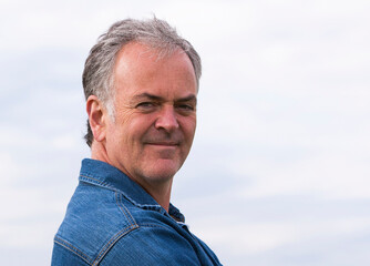 Close up portrait of handsome mature man outdoors.