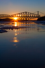 Sun setting behind Quebec City's Old Bridge.